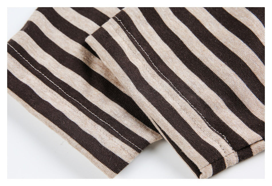 Close-up of brown and beige striped knit fabric showing a stitched seam and folded edge.