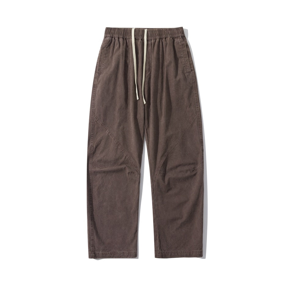 Brown straight-leg drawstring pants with elastic waistband and diagonal seams, flat front view