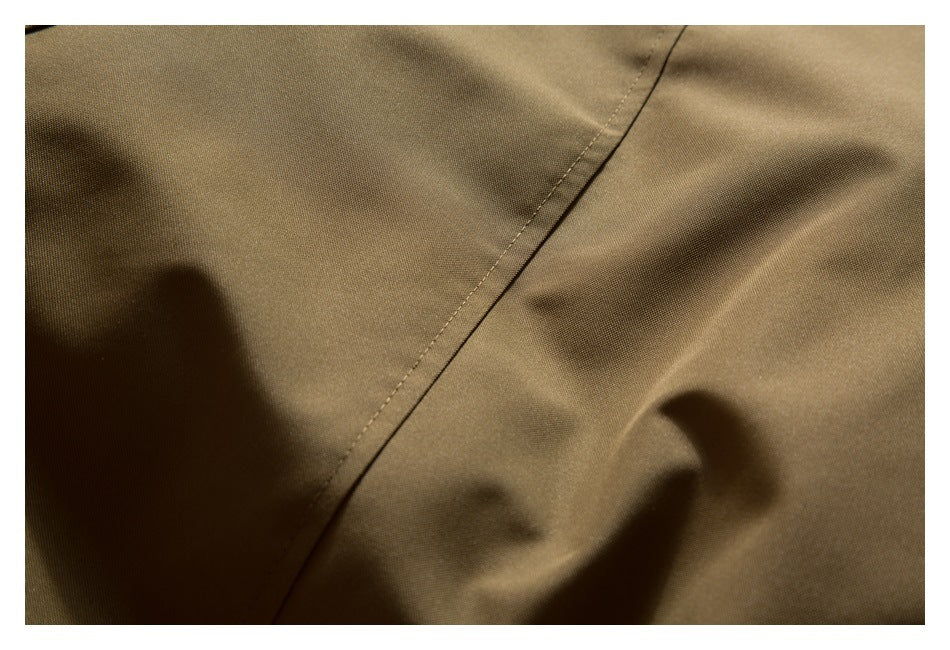 Close-up of tan-brown fabric with a diagonal stitched seam.