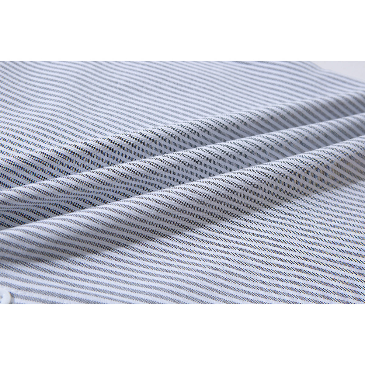 Close-up of fine gray stripes on white shirt fabric, shown folded to reveal the pattern.