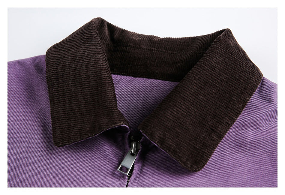 Close-up of a purple jacket's dark ribbed collar and metal zipper.