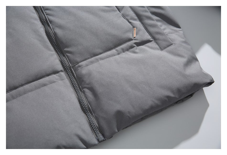 Partial front view of a gray jacket with a central zipper and front pockets, laid flat.