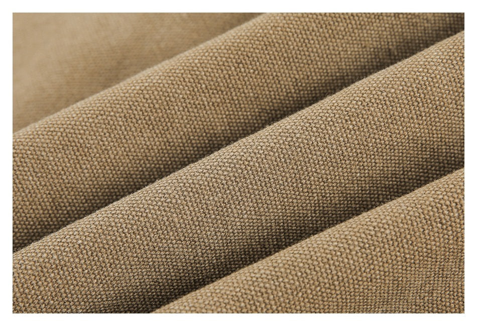 Close-up showing the textured weave and soft folds of tan garment fabric.