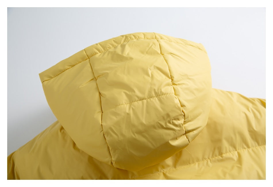 Close-up of the padded hood and quilted seams on a yellow jacket.