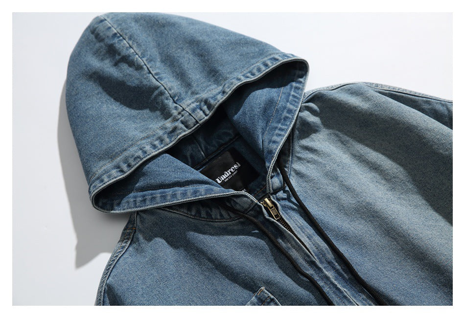 Cropped view of a blue washed-denim hooded jacket with black drawstrings, a front zipper and chest pocket.