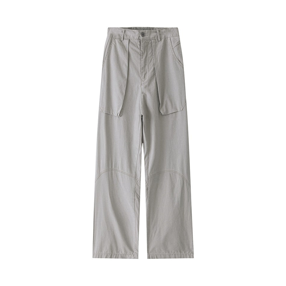 Light gray wide-leg pants flat lay, front view with button fly, large flap pockets and curved knee seams
