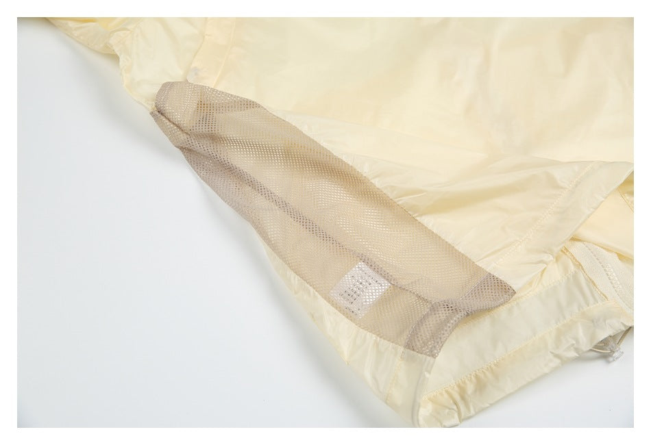 Close-up of a pale yellow garment showing a beige mesh ventilation panel along an inner seam.