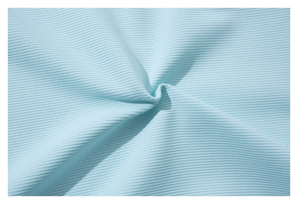 Close-up of light blue ribbed fabric gathered into a small fold.
