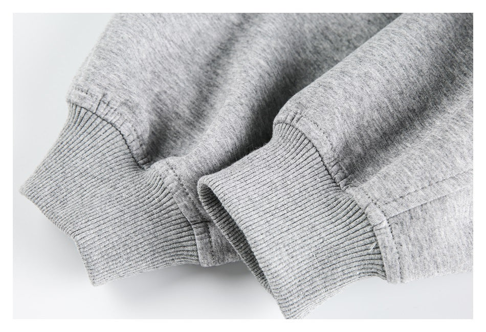 Close-up of two heather-gray ribbed cuffs and their stitched sleeve seams.