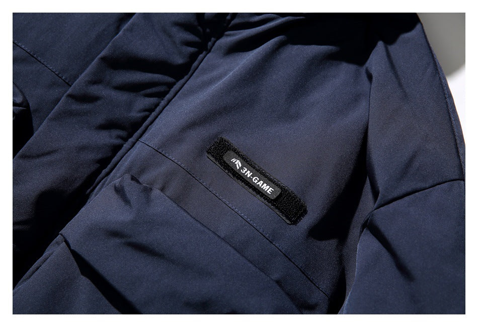 Close-up of a small black sewn label on the dark navy jacket.