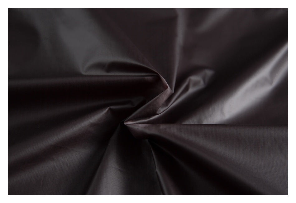 Close-up showing the smooth, dark charcoal fabric gathered into folds.