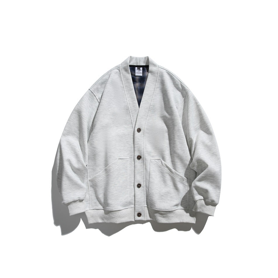 Light heather gray V-neck button-front cardigan jacket with two large front pockets and ribbed cuffs, flat lay
