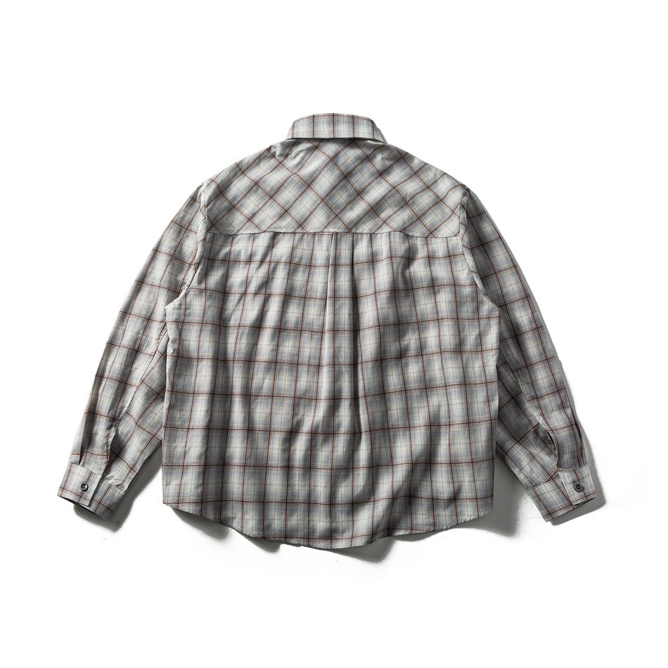 Back view of gray plaid long-sleeve shirt with diagonal plaid yoke and center pleat, laid flat