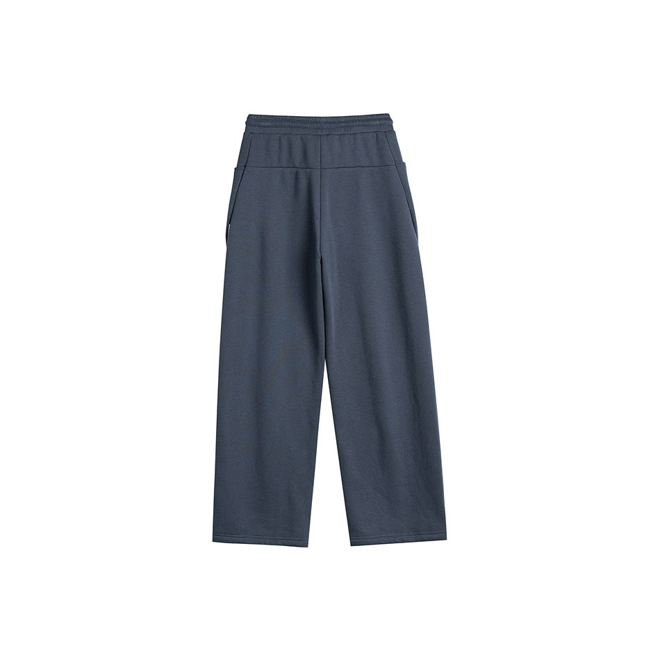 Back view of dark slate blue-gray wide-leg sweatpants with elastic waistband, back yoke seam and side pockets