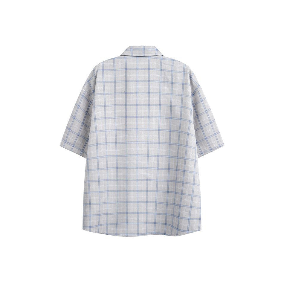 Back view of light gray short-sleeve shirt with blue and white plaid pattern and dropped shoulders