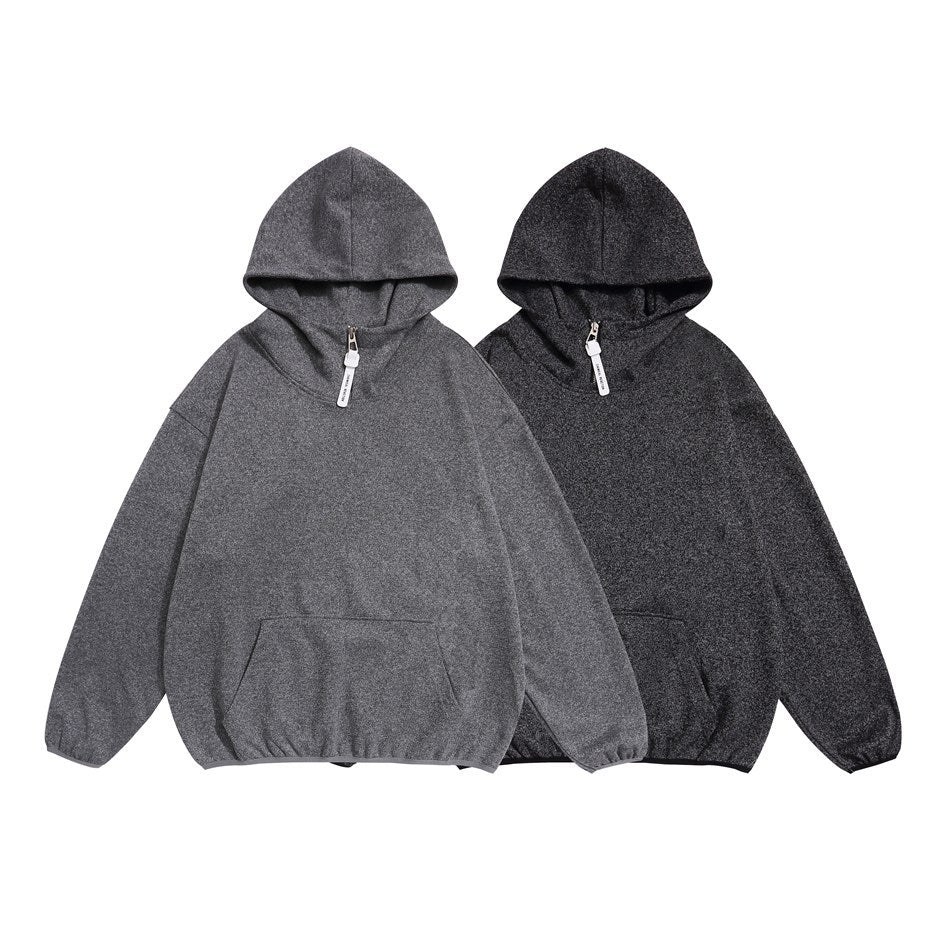 Two hooded pullovers shown from the front in medium gray and dark charcoal, each with a short zipper and kangaroo pocket.