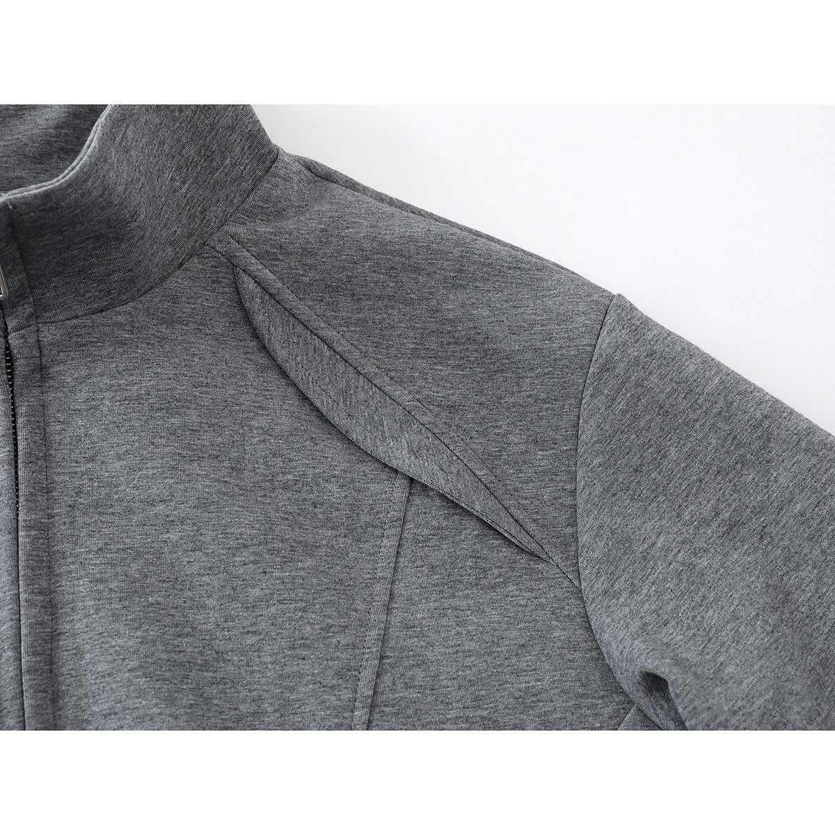 Close-up of the gray jacket's shoulder and sleeve seams.