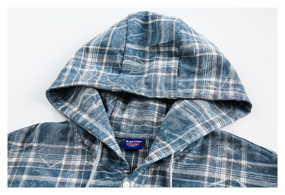 Close-up of a blue-and-white plaid shirt with a hood and visible sewn-in neck label.