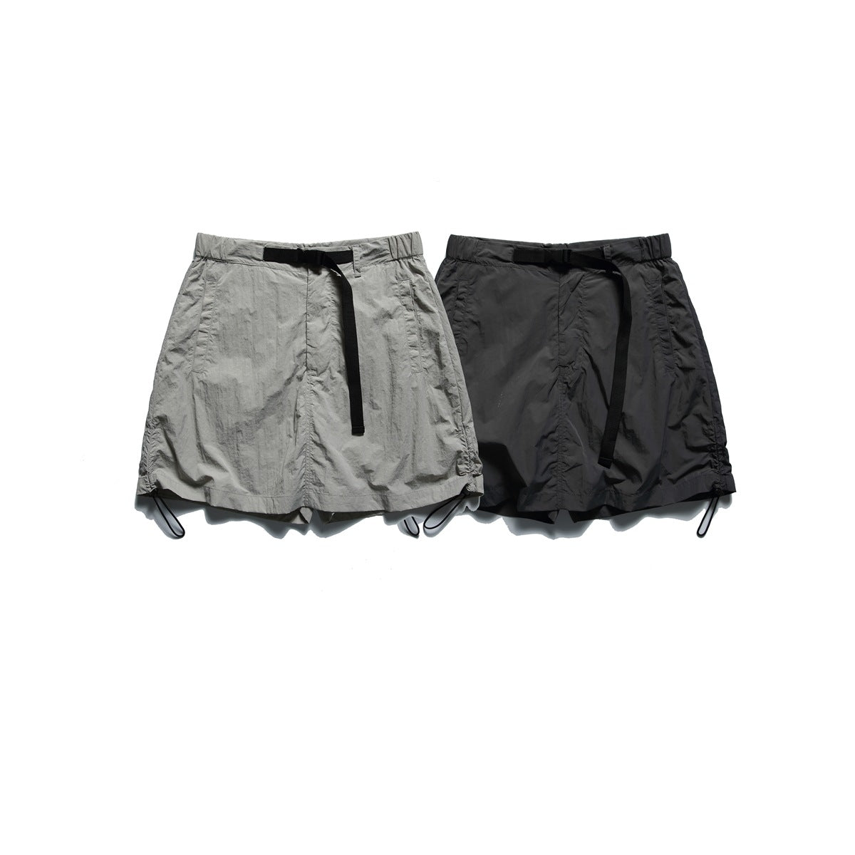 Front view of gray and black pull-on shorts or skorts with black webbing belts and adjustable hems.