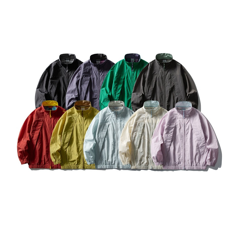 Nine zip jackets displayed in black, purple, green, charcoal, red, yellow, pale blue, cream, and lavender.