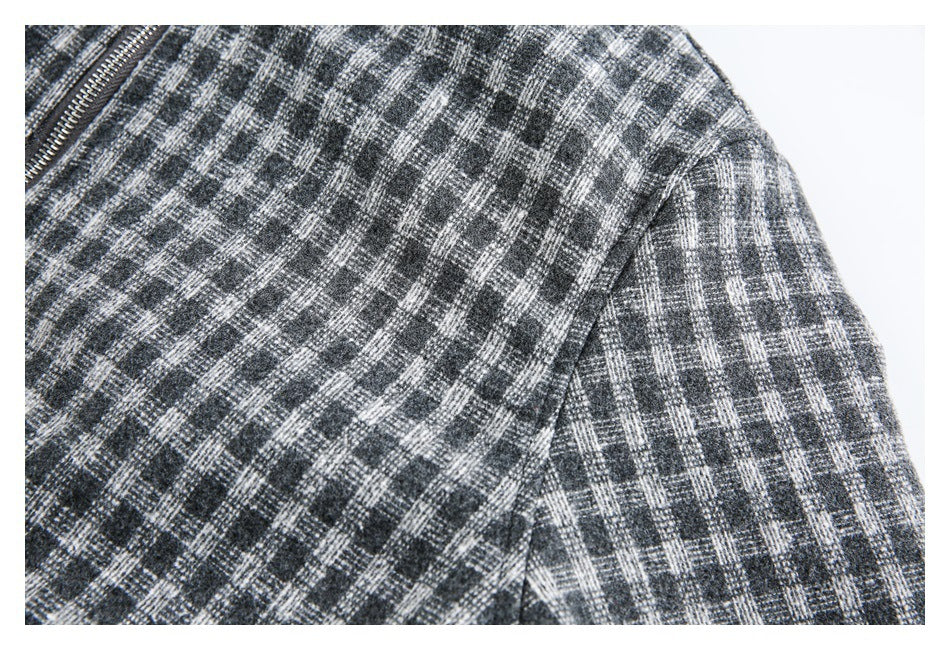 Close-up of the gray plaid jacket's shoulder seam and checked fabric.