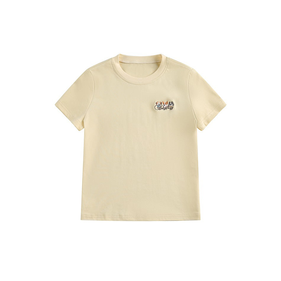 Light yellow short-sleeve crew-neck T-shirt with a small embroidered dog-face patch on the left chest, flat lay