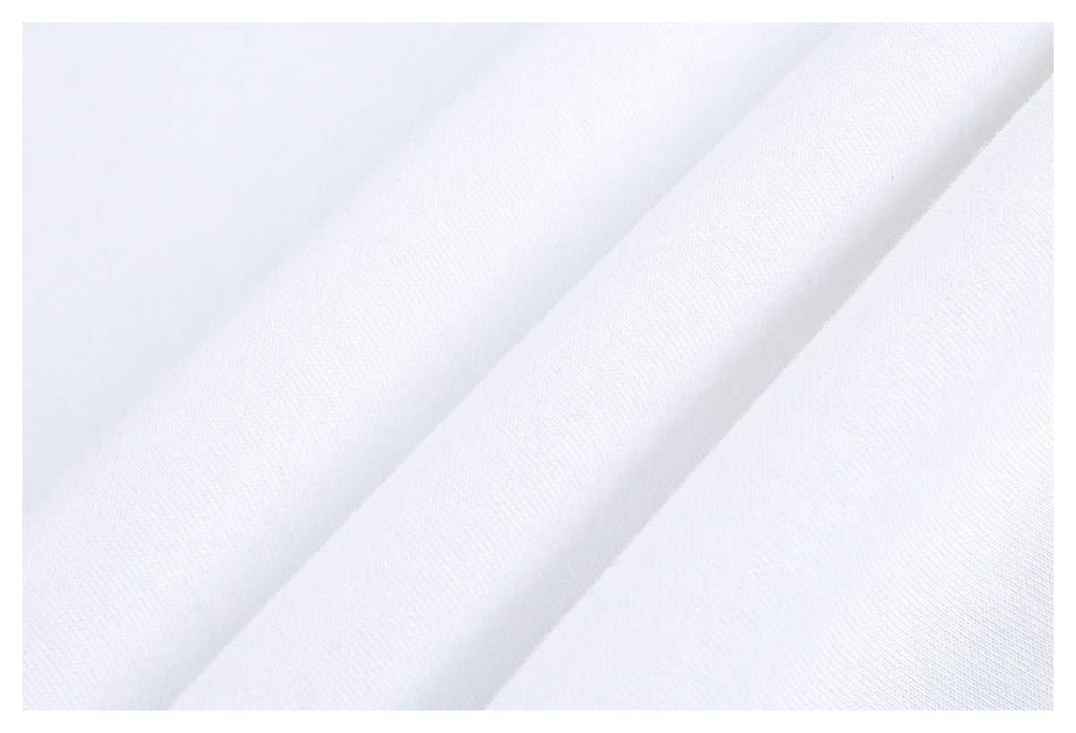 Close-up of white garment fabric arranged in soft folds, showing its surface texture.