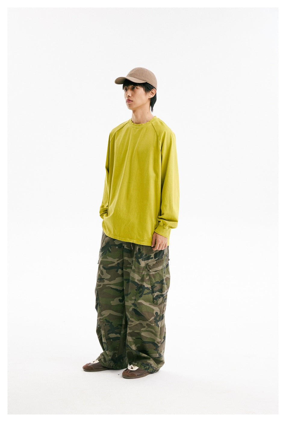 Model wearing a bright yellow-green oversized long-sleeve raglan shirt, shown from the front at a slight angle.