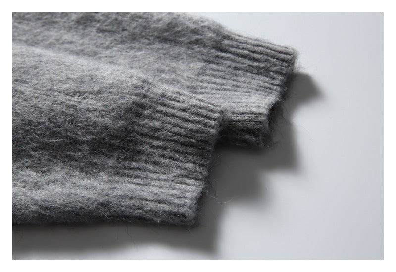 Close-up of a gray knit sleeve ending in a ribbed cuff.