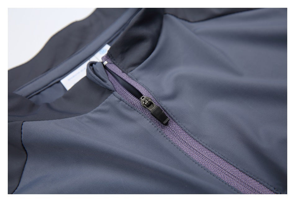 Close-up of a slate-gray athletic top's neckline and purple-gray zipper.
