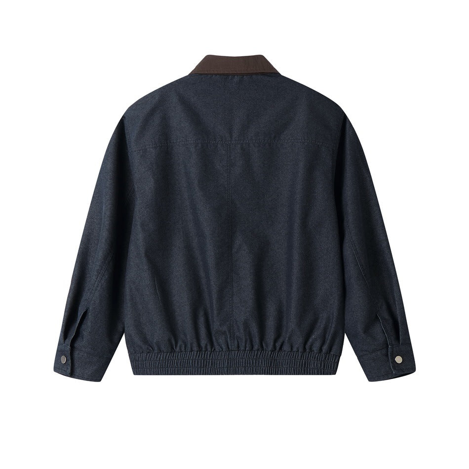 Back view of denim-blue jacket with brown collar, back yoke seam, elastic hem and snap button cuffs