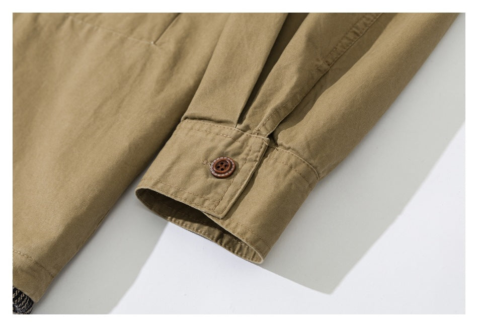 Close-up of a tan garment sleeve ending in a buttoned cuff.