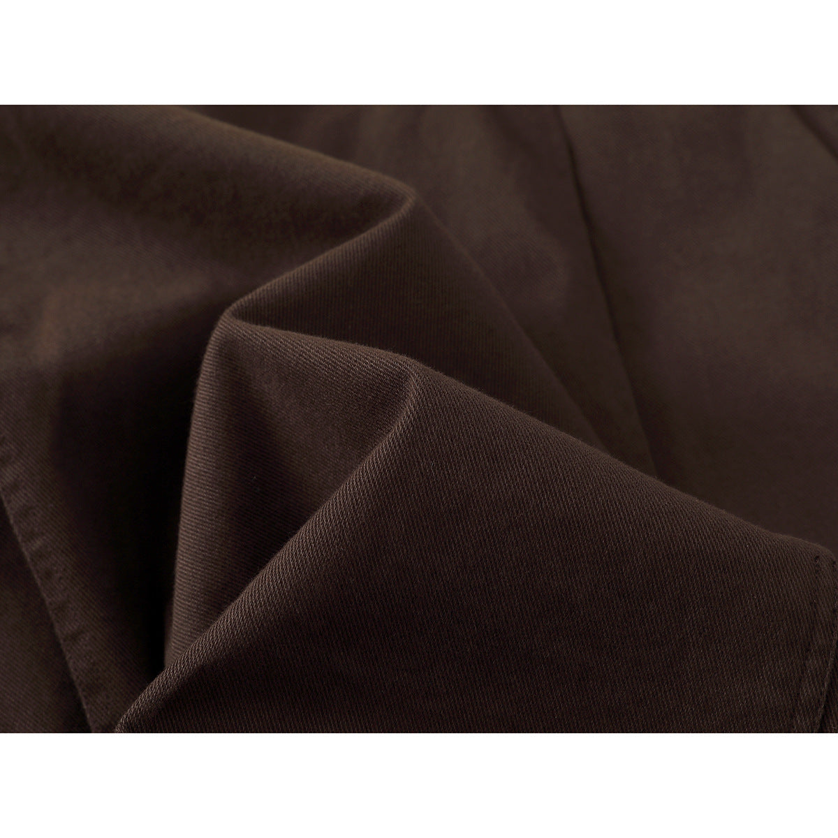 Close-up of dark brown fabric shown in soft folds.