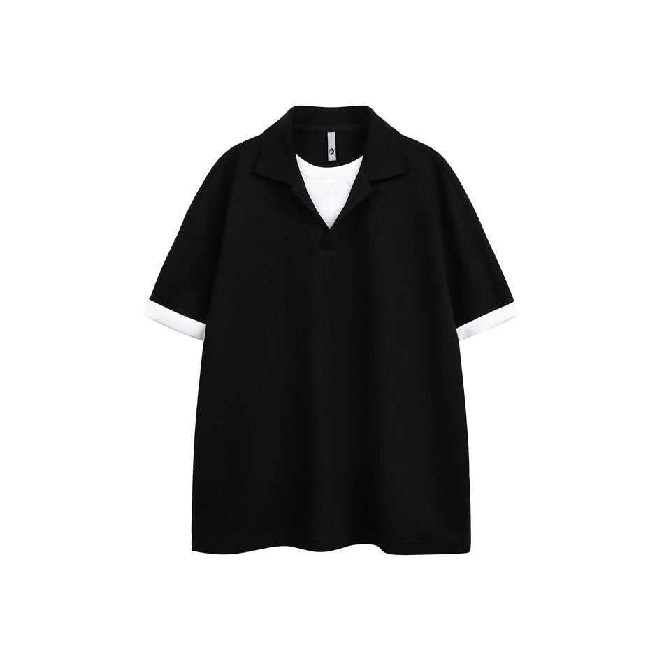 Black short-sleeve polo-style top with white layered neckline insert and white cuffs, flat front view