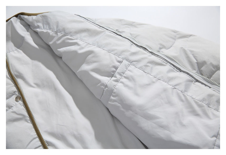 The white quilted jacket is opened to show its smooth white interior and front zipper.