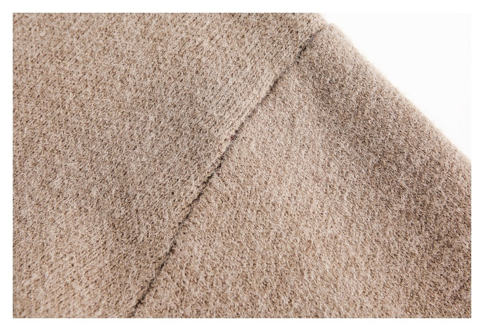 Close-up of the taupe sweater's knit texture and shoulder seam.
