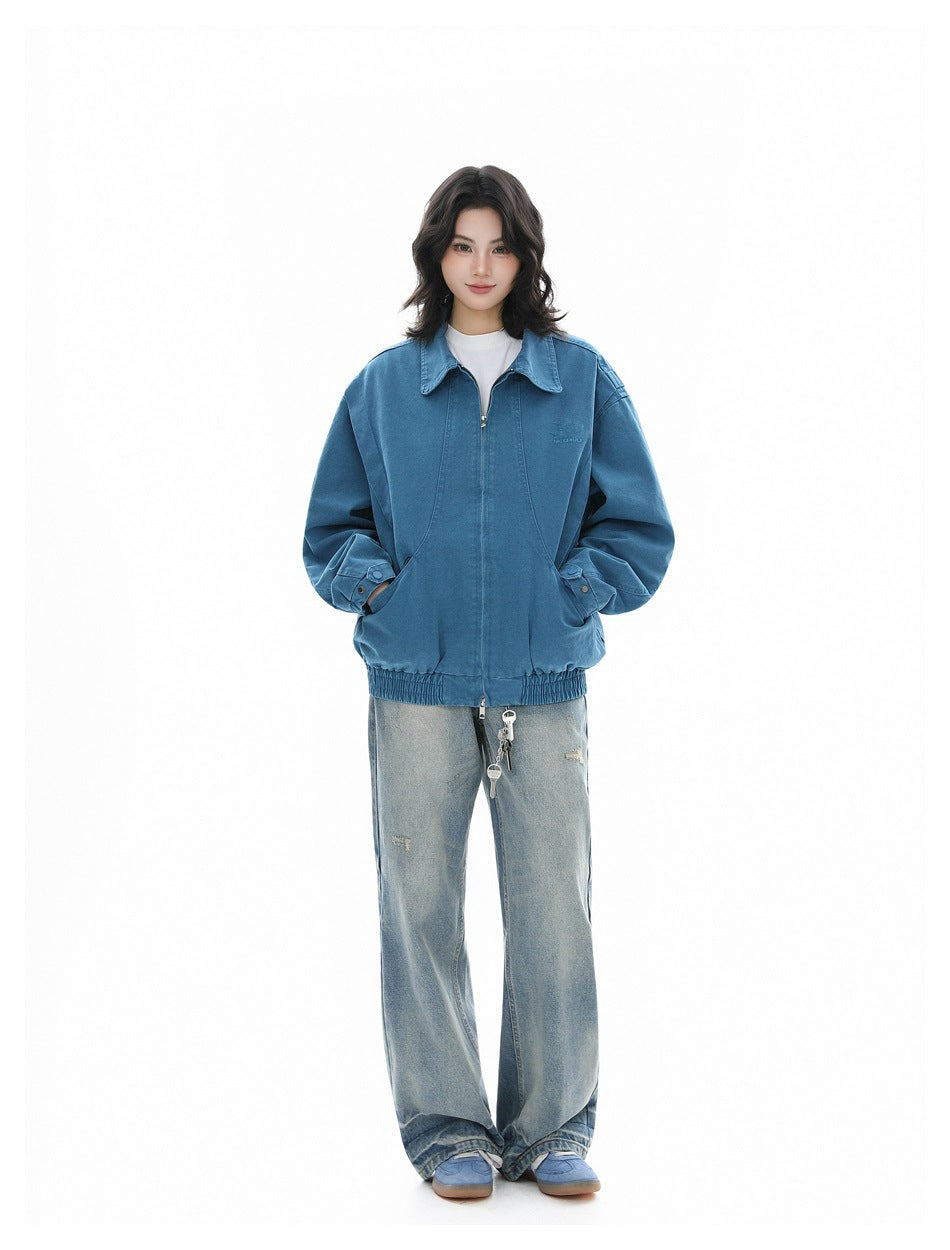 Full-length front view of a model wearing a blue oversized jacket and loose light-wash jeans.