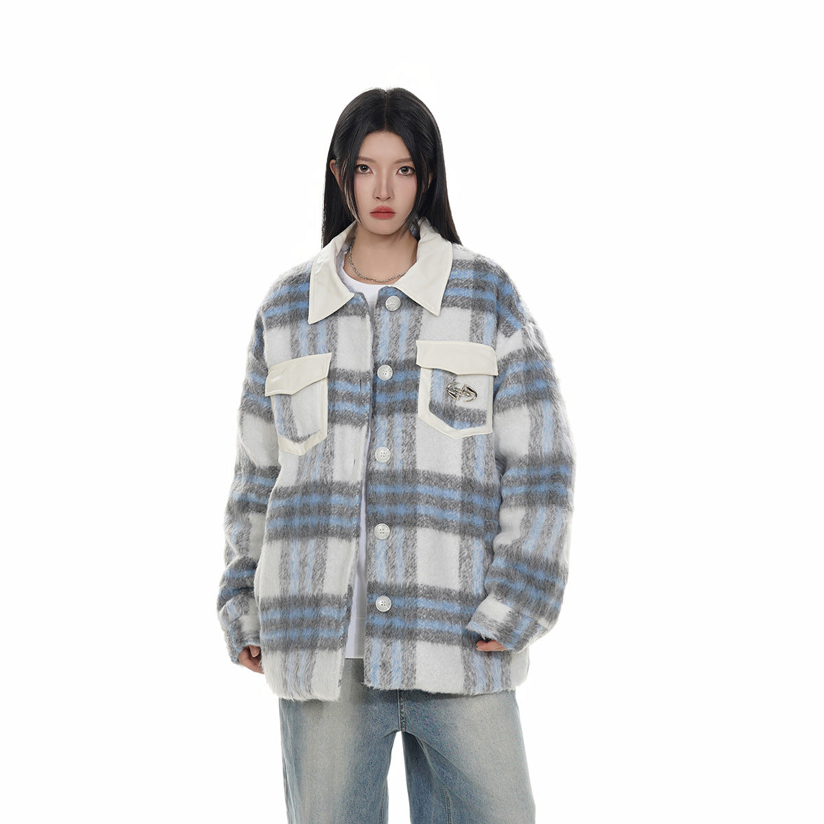 Front view of a model in a gray, white and blue plaid jacket with a cream collar and pockets.