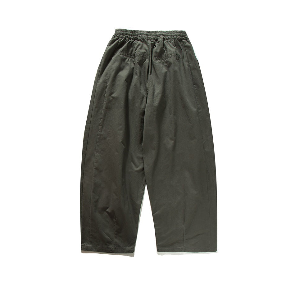 Rear view of dark charcoal wide-leg trousers with an elastic waistband and two back pockets.