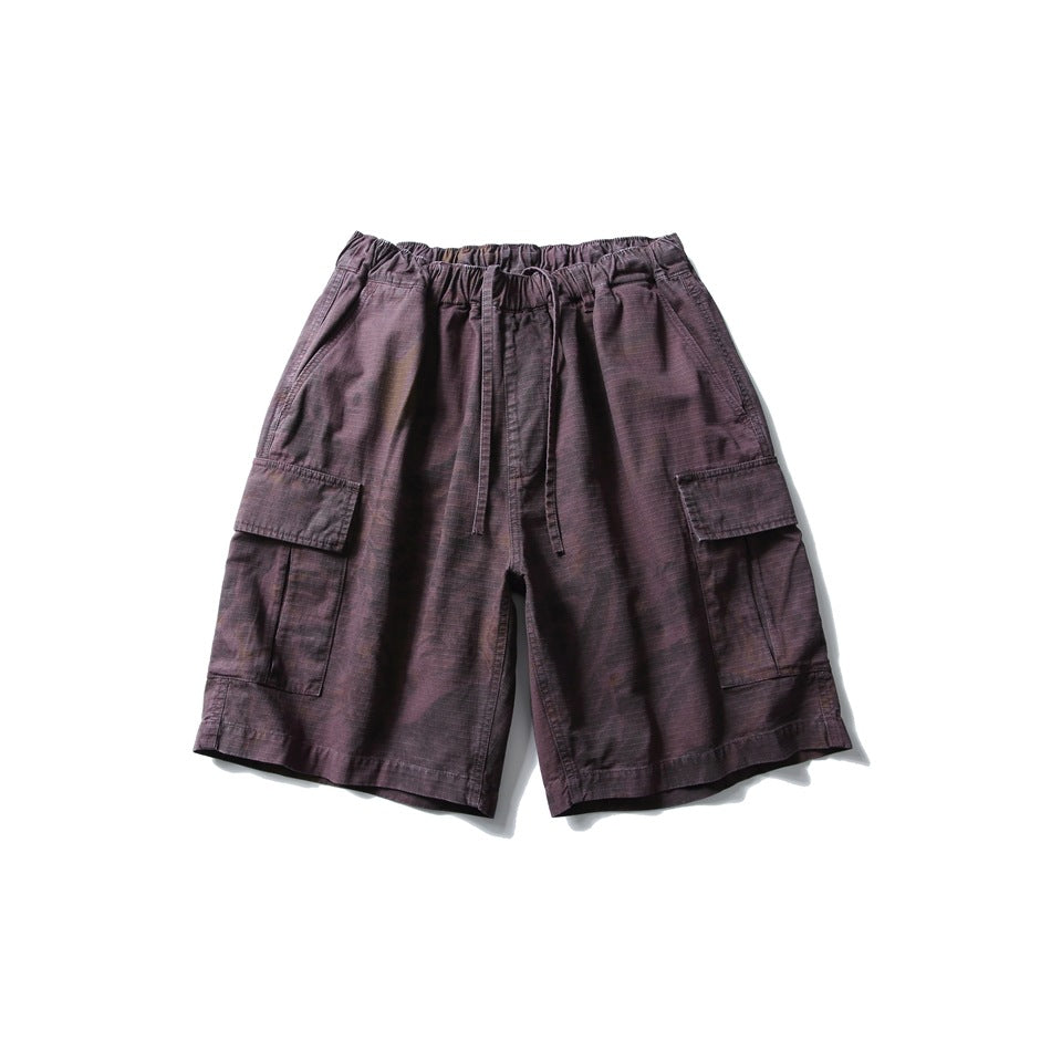 Front view of dark plum cargo shorts with an elastic drawstring waist and large flap pockets on both legs.