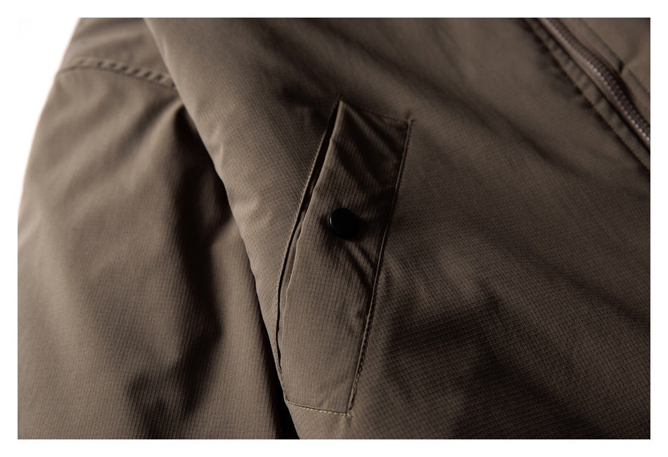 Close-up of a brown jacket with a snap-button pocket flap and zipper.