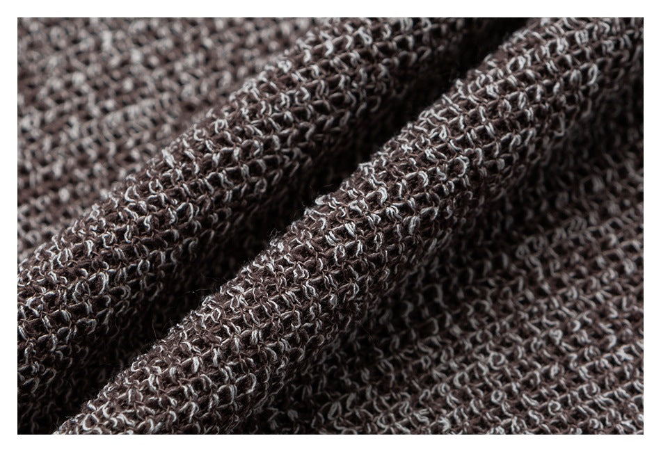 Macro view of the cardigan's chunky taupe and gray marled knit texture.
