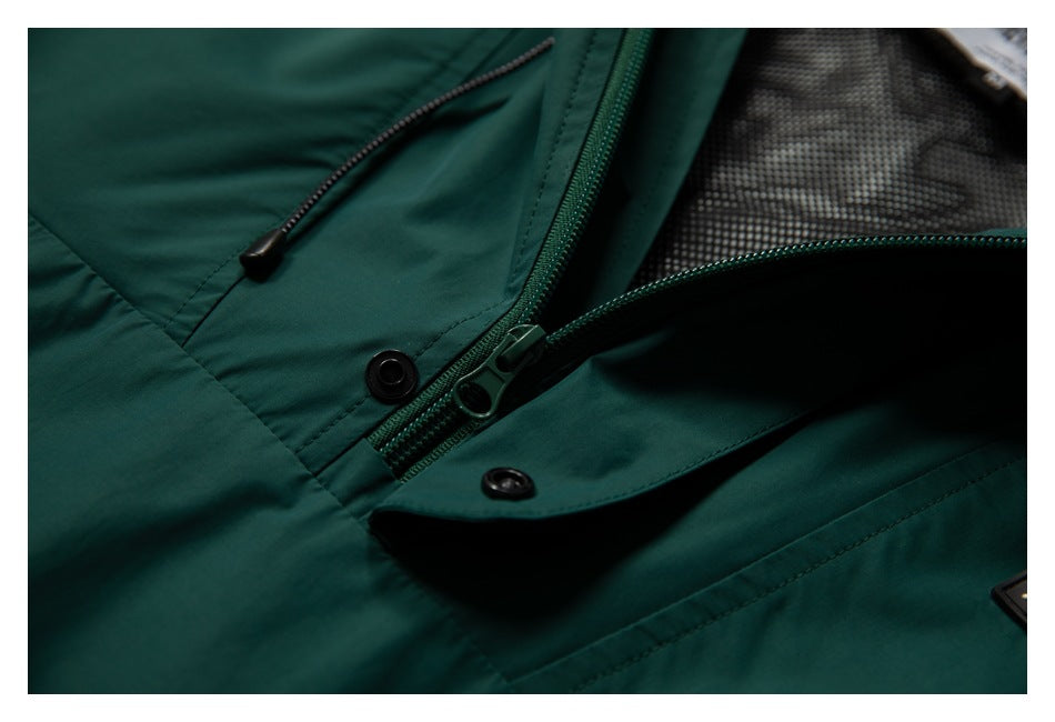 Close-up of the dark teal jacket opened to show its front zipper, snap-fastened storm flap, and mesh lining.
