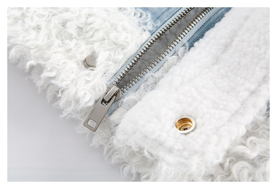 Close-up of a metal zipper and snap fastener between denim and white curly trim.