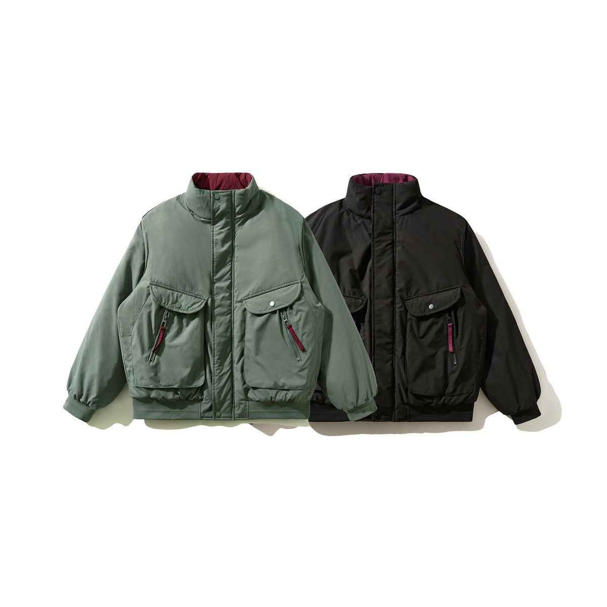 Two jackets shown from the front: one sage green and one black, both with high collars and large front pockets.