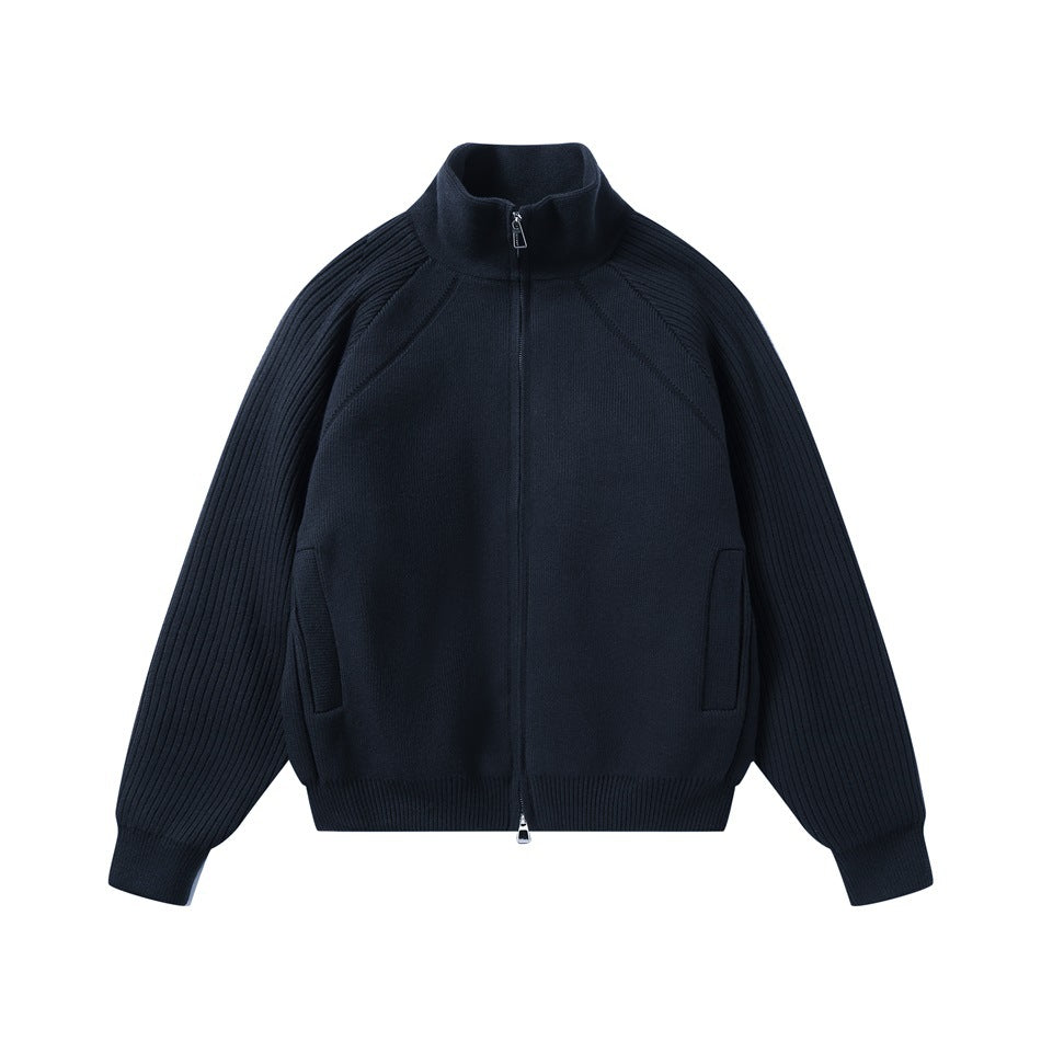 Navy zip-front knit jacket with a stand collar, ribbed raglan sleeves, and two front pockets.