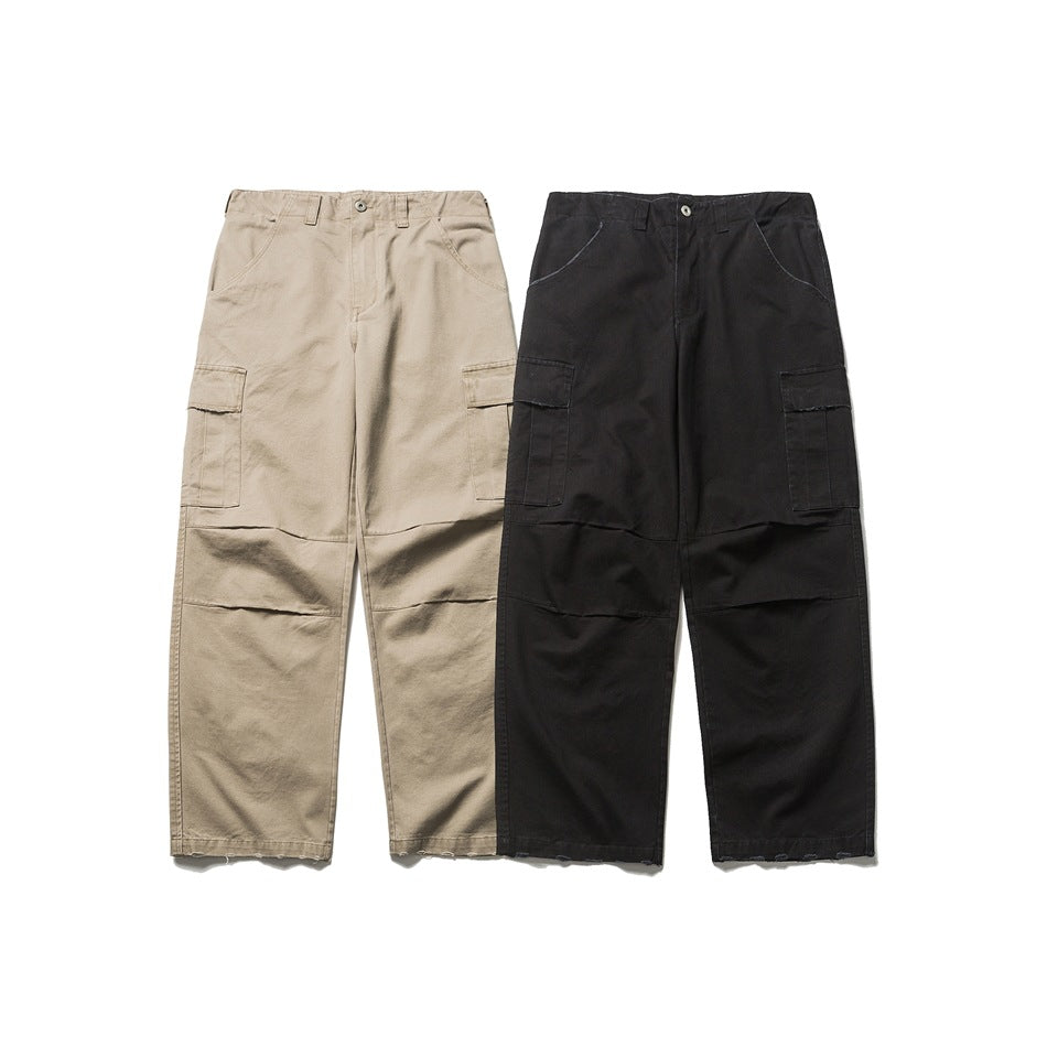 Front view of beige and black cargo trousers displayed side by side, with roomy legs and side pockets.