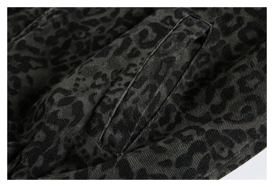 Close-up of a welt pocket and leopard-print fabric on the dark jacket.