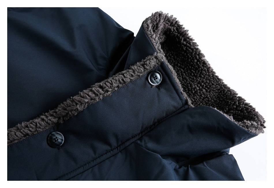 Close-up of a dark navy coat edge with charcoal fuzzy lining and two dark buttons.
