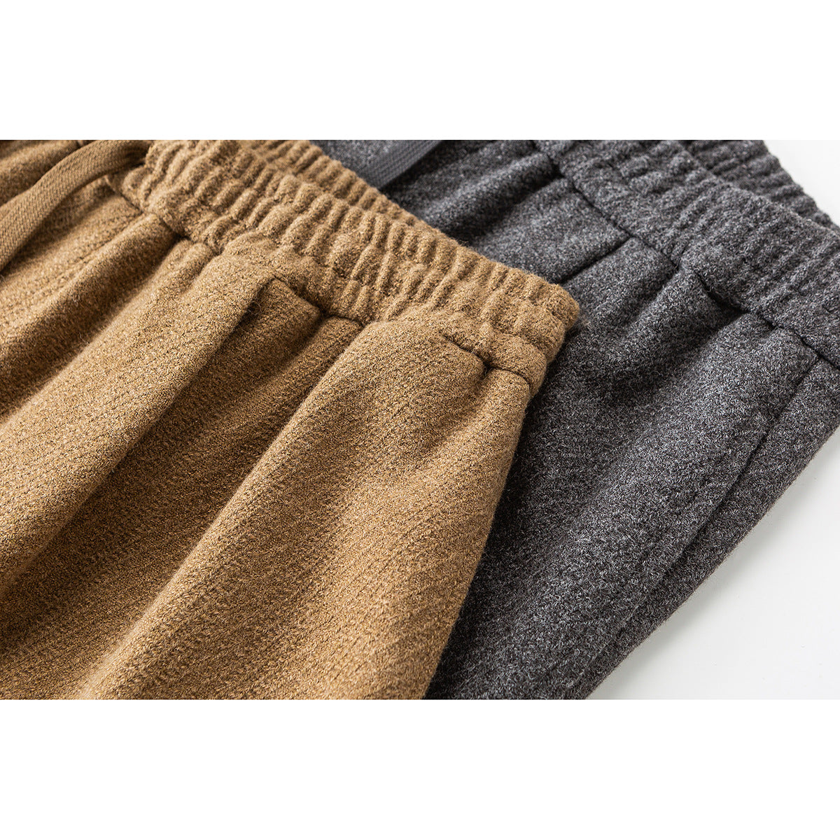 Close-up of gathered waistbands and fabric on tan and charcoal wide-leg pants.